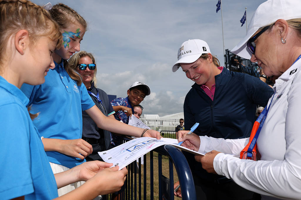 Lottie Woad (second right) signs autographs at Royal Porthcawl